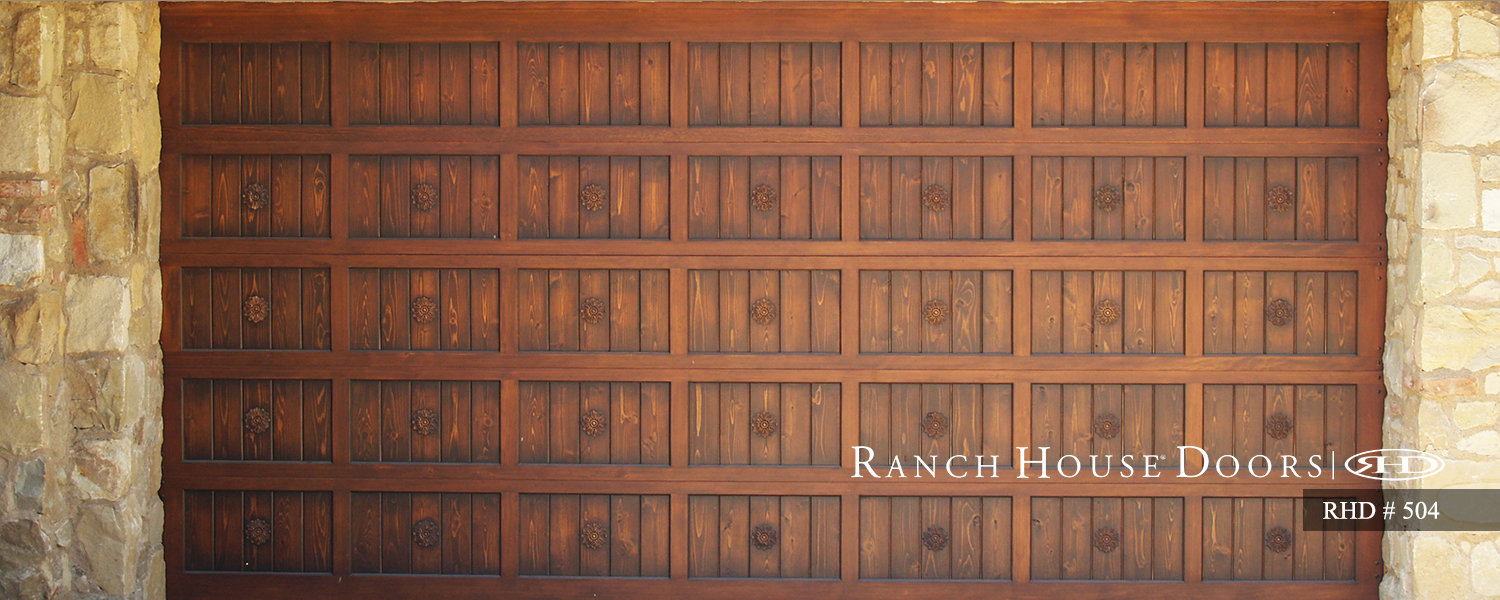 This is an image of a Spanish style wood garage door with decorative designs in Laguna Niguel, CA.