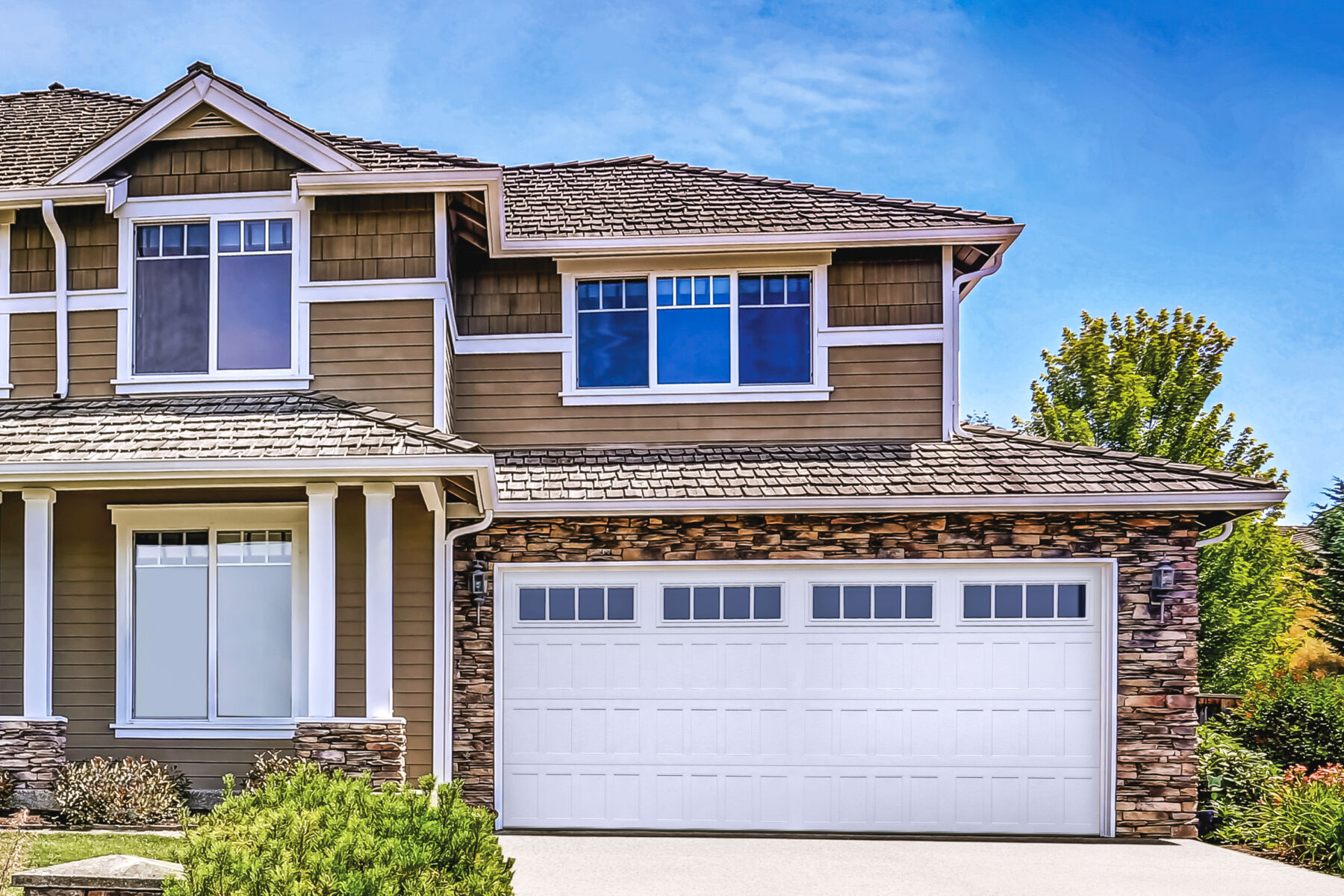 This is an image of a white steel garage door with windows in Orange County CA.