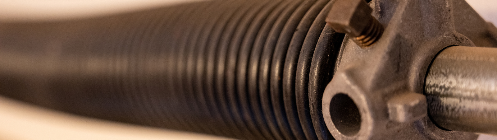 This is a picture of a torsion spring for a garage door.