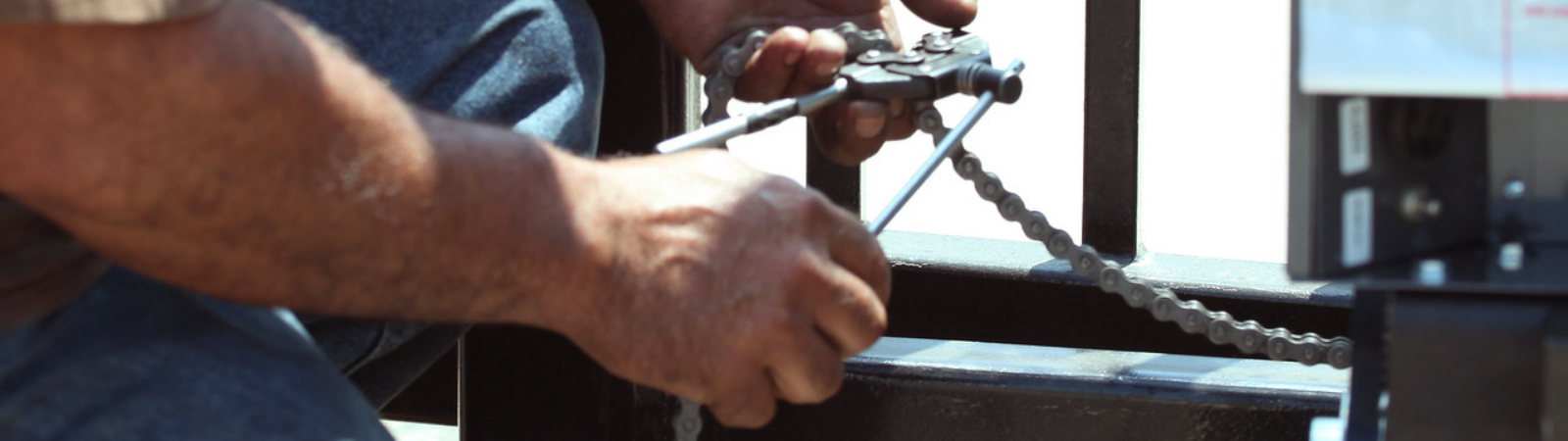 This is an image of a man replacing a driveway gate chain in Irvine, California.