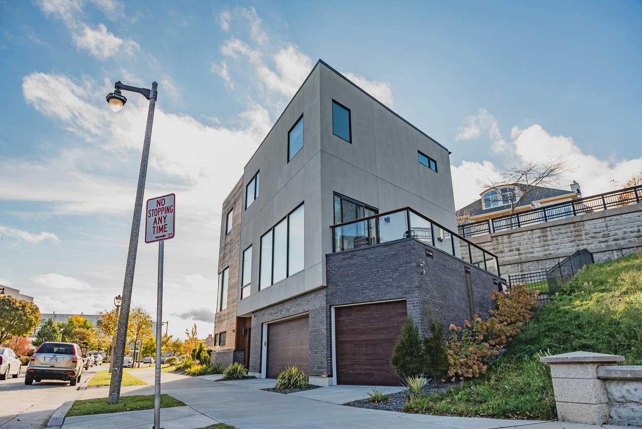 This is an image of a modern home with steel garage doors that look like wood.