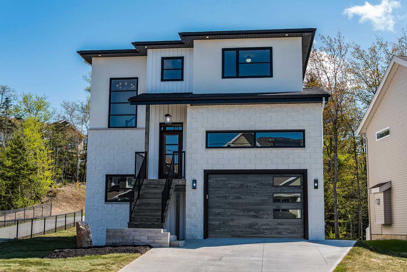 This is an image of a steel garage door that looks like carbon oak on a modern home.