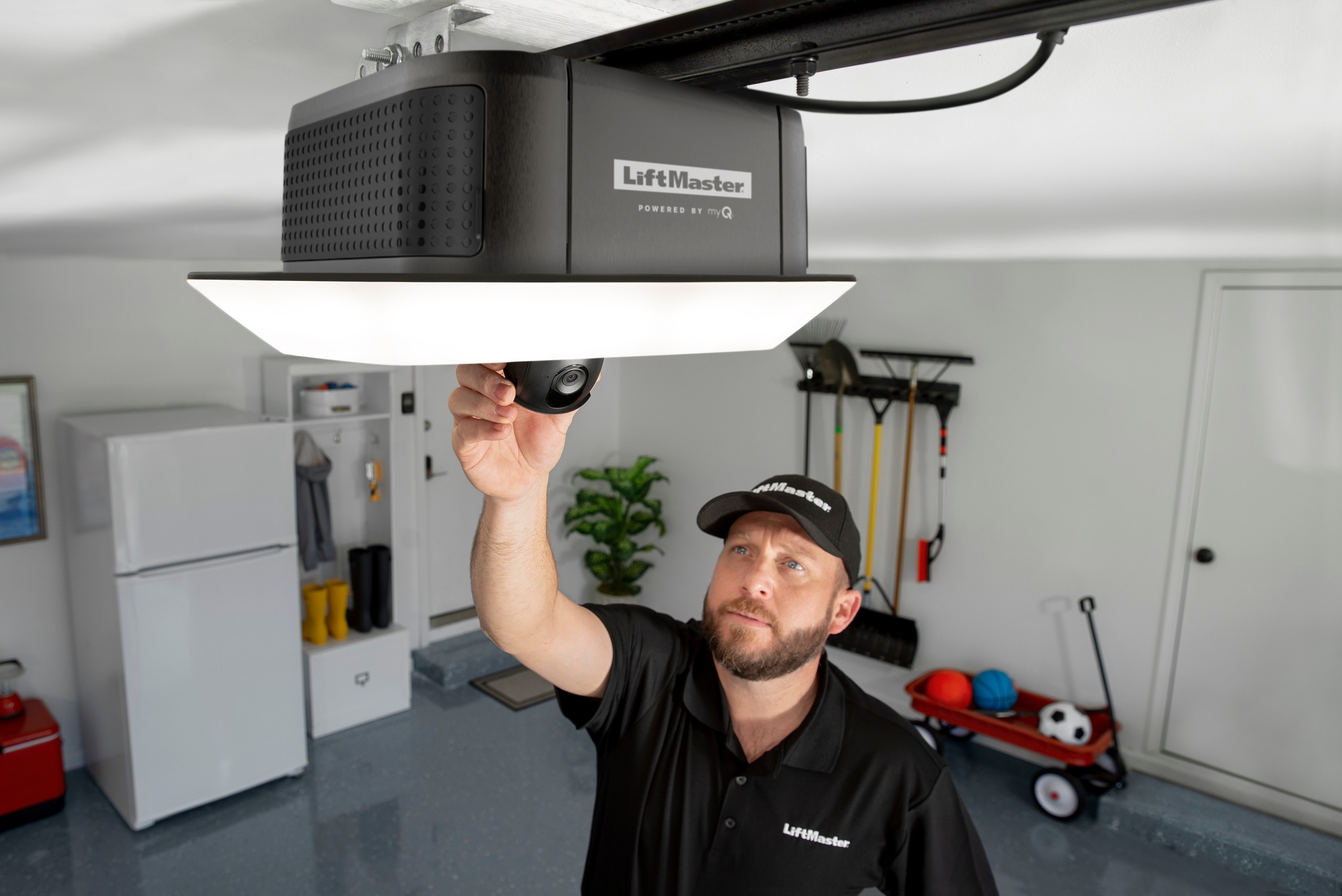 This is an image of a garage door technician working on a Liftmaster garage door opener.