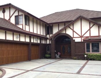 This is the after image of a steel Amarr Classica garage door installed in Laguna Hills in the Golden Oak color.