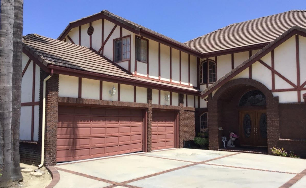 This is an image of a wood garage door in Laguna Hills, CA before it was replaced by Entry Systems.