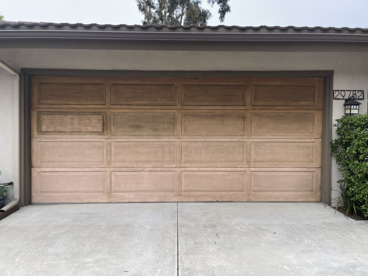 This is the before image of a traditional garage door in Laguna Niguel, CA.