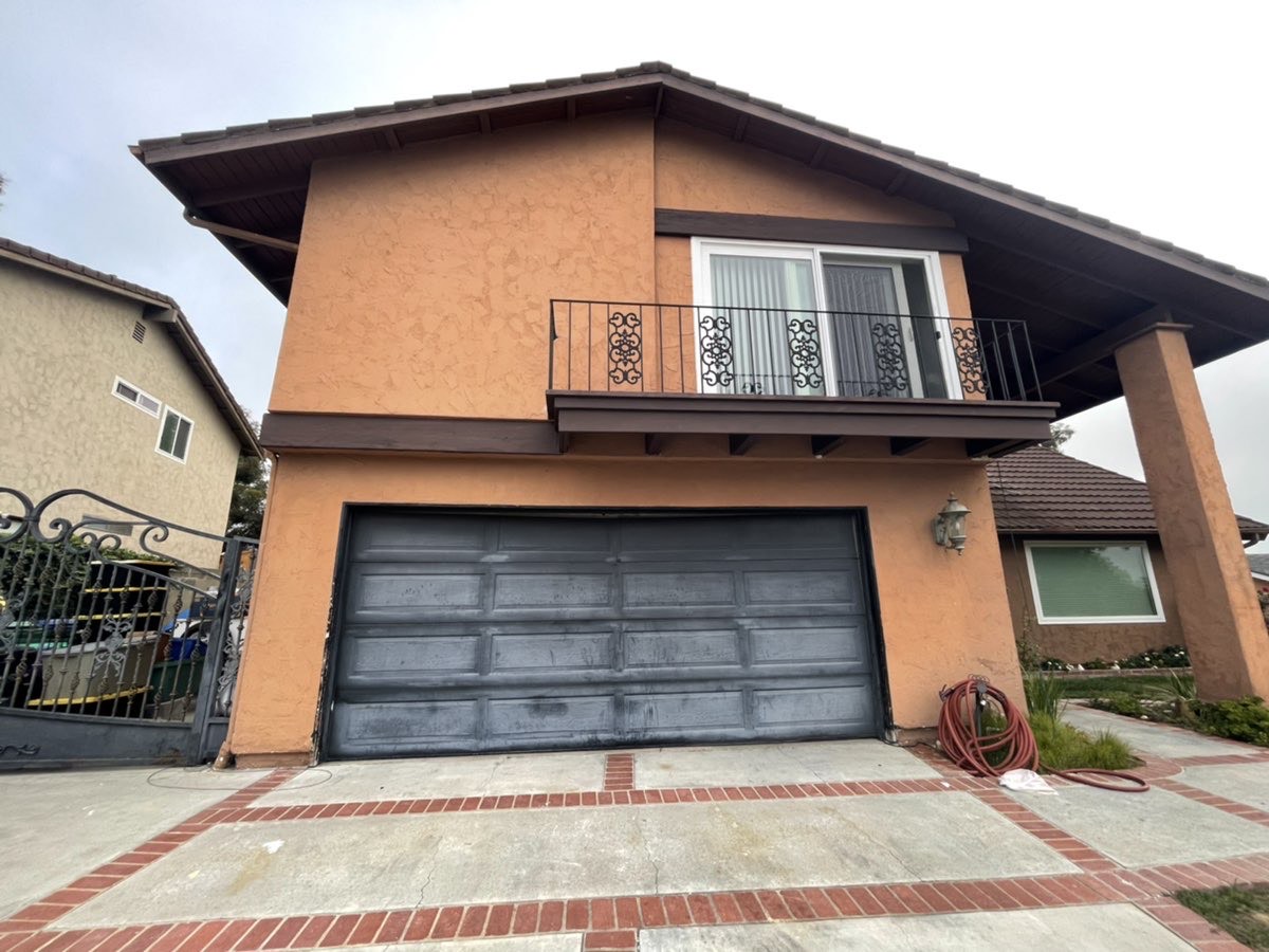 This is an image of a faded black door before replacement in Laguna Beach, CA.