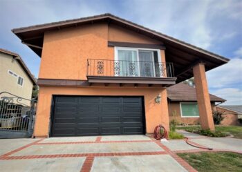 This is an image of a black raised long panel garage door in Laguna Beach, CA.