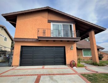 This is an image of a black raised long panel garage door in Laguna Beach, CA.