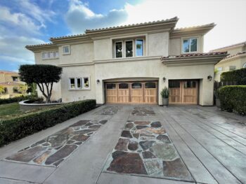 This is the after image of a new garage door project, a red cedar custom wood garage door in San Juan Capistrano.
