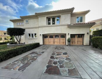 This is the after image of a new garage door project, a red cedar custom wood garage door in San Juan Capistrano.