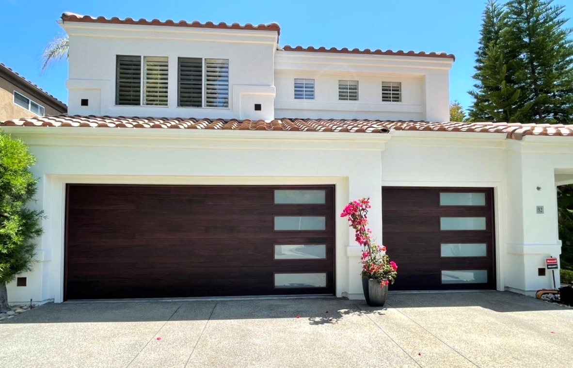 This is the after image of a new garage door project, it is a modern faux wood garage door in Laguna Niguel, California.