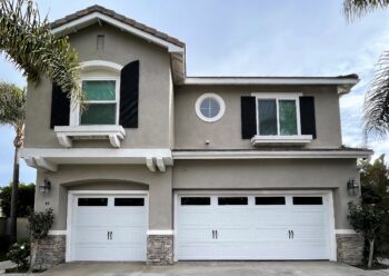 This is the after image of a new garage door project, it is a white modern barn style garage door in Aliso Viejo.