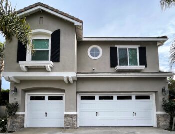 This is the after image of a new garage door project, it is a white modern barn style garage door in Aliso Viejo.