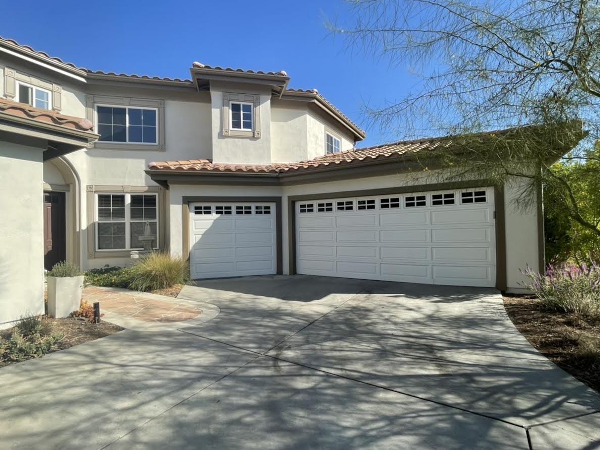 This is the before image of a long panel white garage door in Rancho Santa Margarita, CA.