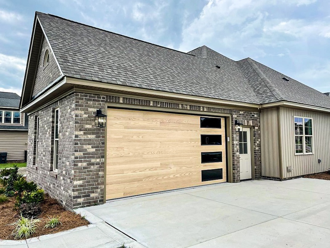 This an image of a faux natural wood garage door.