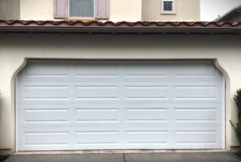 This is the after picture of a long panel style garage door replacement in Ladera Ranch, CA.