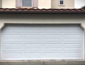 This is the after picture of a long panel style garage door replacement in Ladera Ranch, CA.