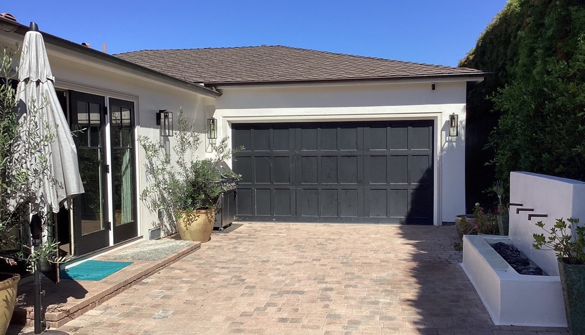 This is the before image of a modern black garage door installation in Laguna Beach, CA.