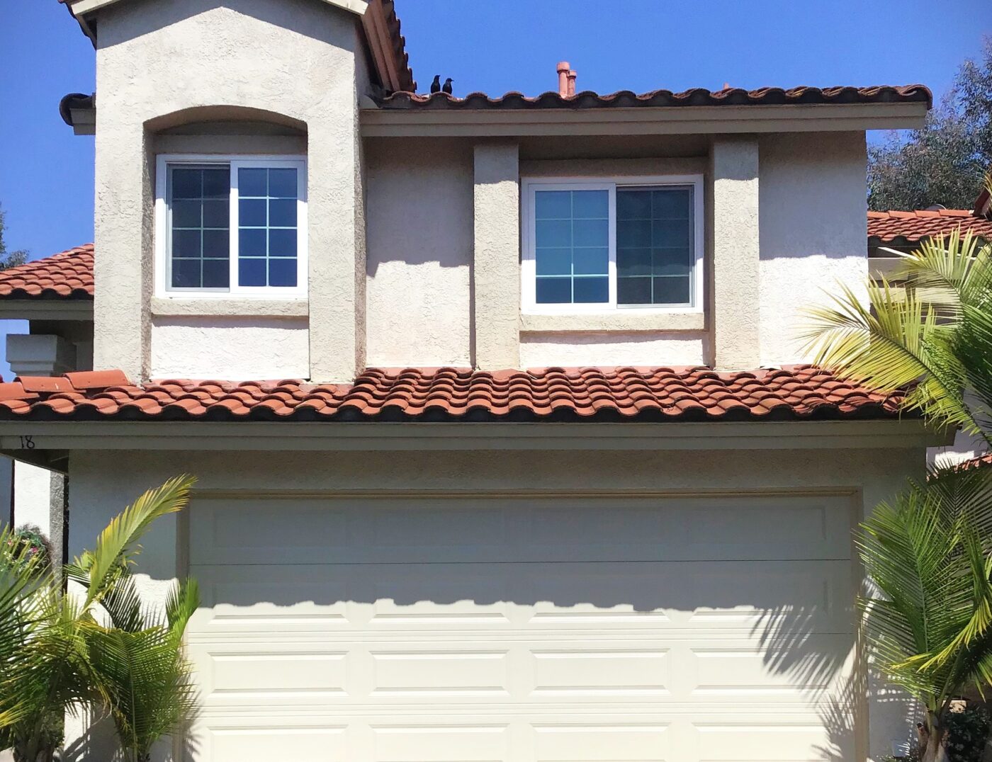 This is the after image of a garage door replacement in Rancho Santa Margarita, CA. It is a tan long panel garage door with no windows.