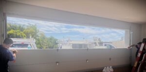 shows a garage door installation in progress with the hinges being attached and the tracks being adjusted