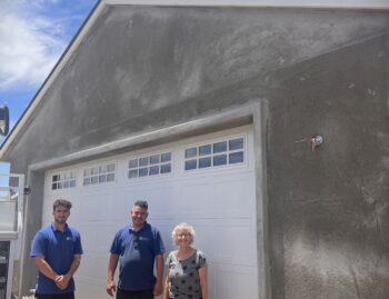 Image of Fallbrook Garage Door Job after installation is completed with two installers and owner.