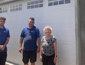 Image of Fallbrook Garage Door Job after installation is completed with two installers and owner.