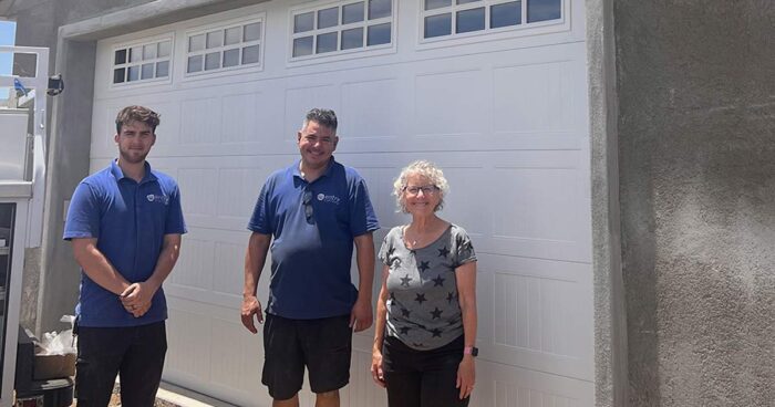 Image of Fallbrook Garage Door Job after installation is completed with two installers and owner.