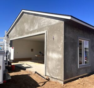 Image of Fallbrook Garage Door Job before installation is completed with two installers and owner.