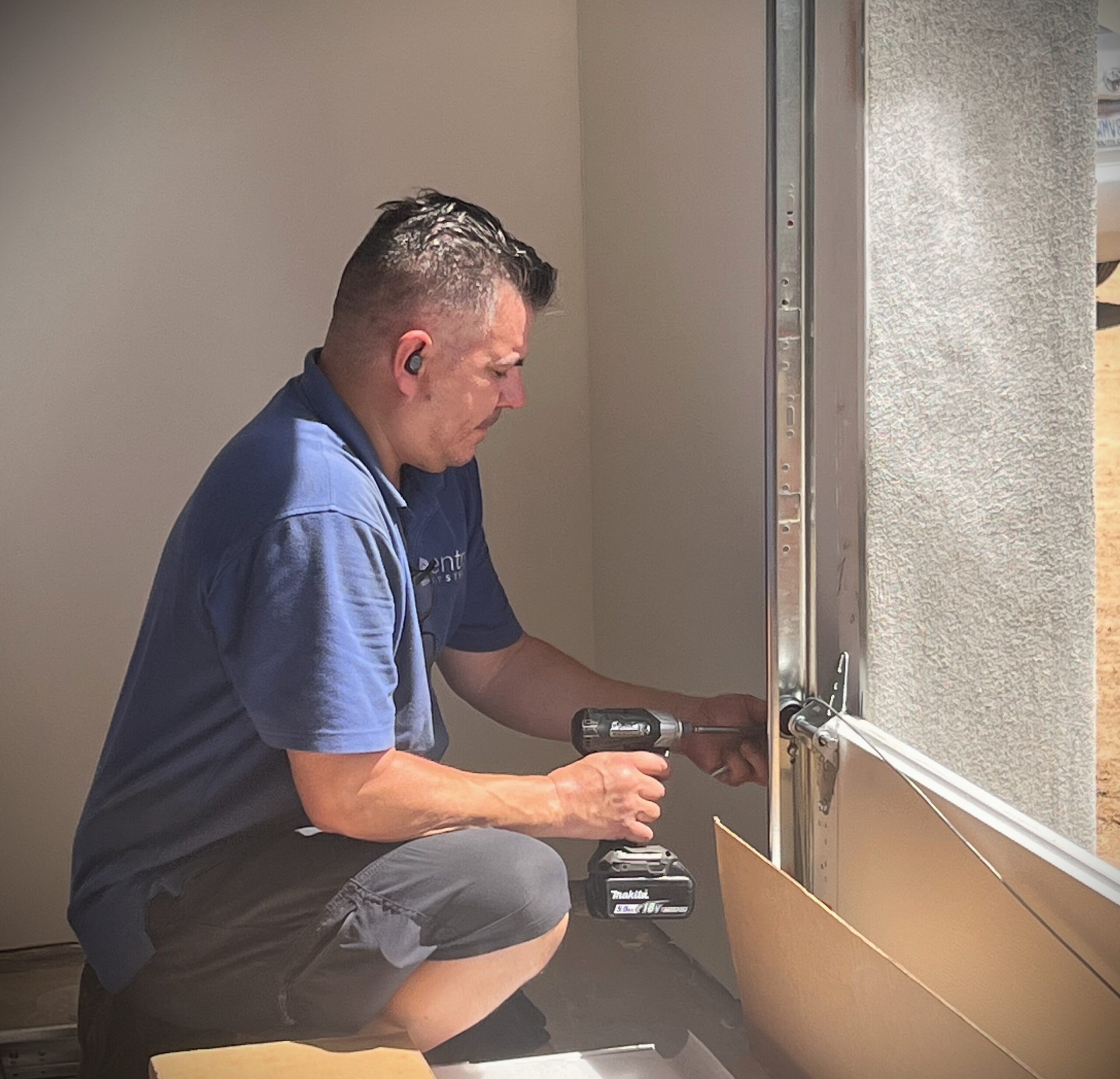 garage door installer is securing the jamb bracket
