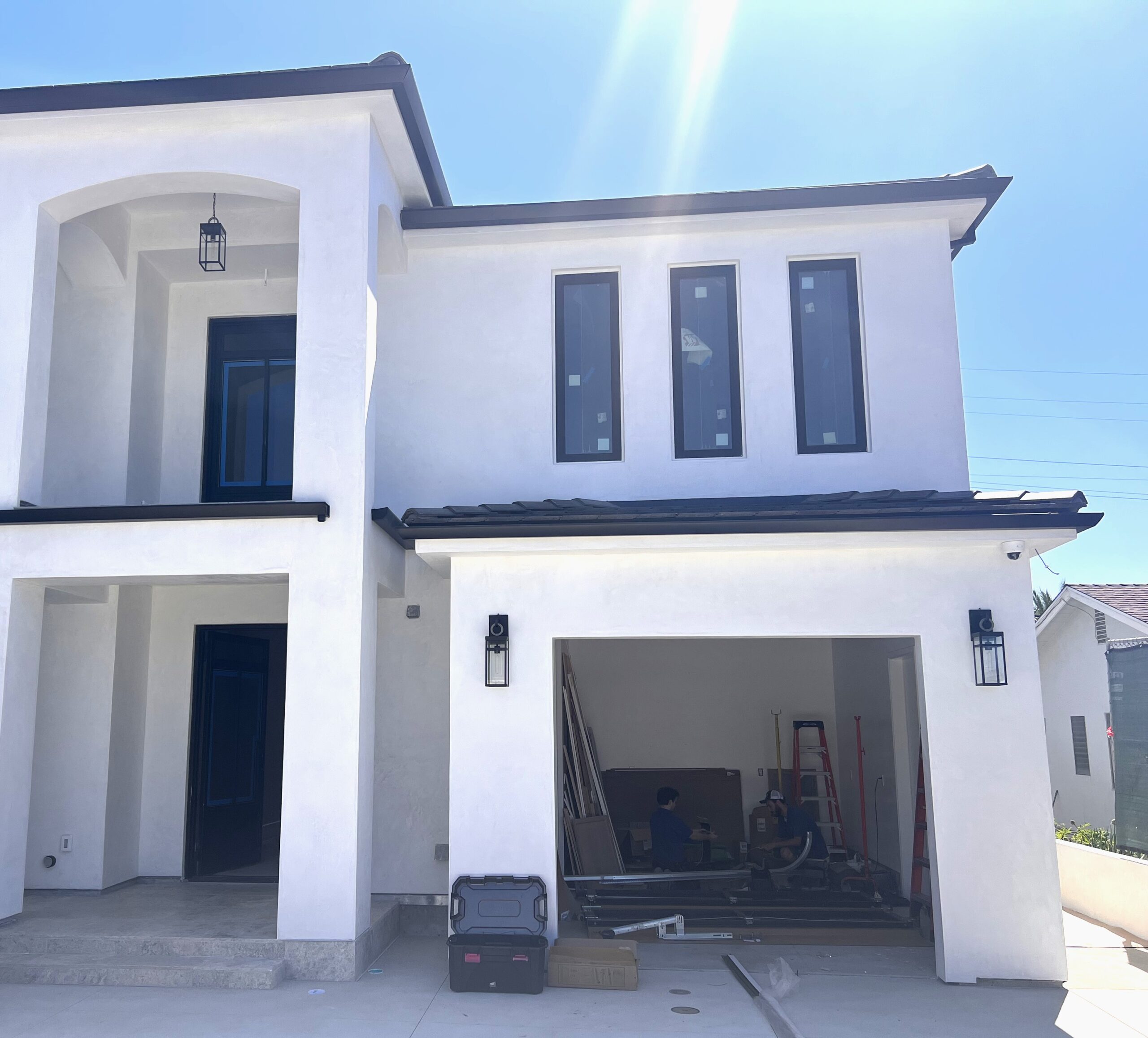 Before image of black garage door install- no garage door present.
