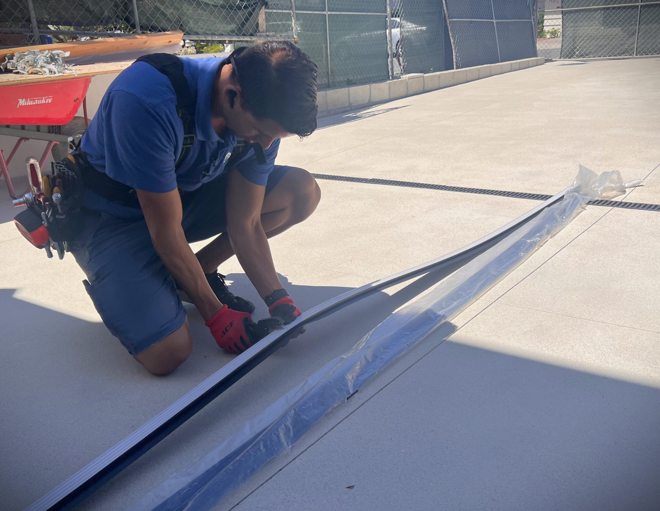 Garage door installer cutting weather strip