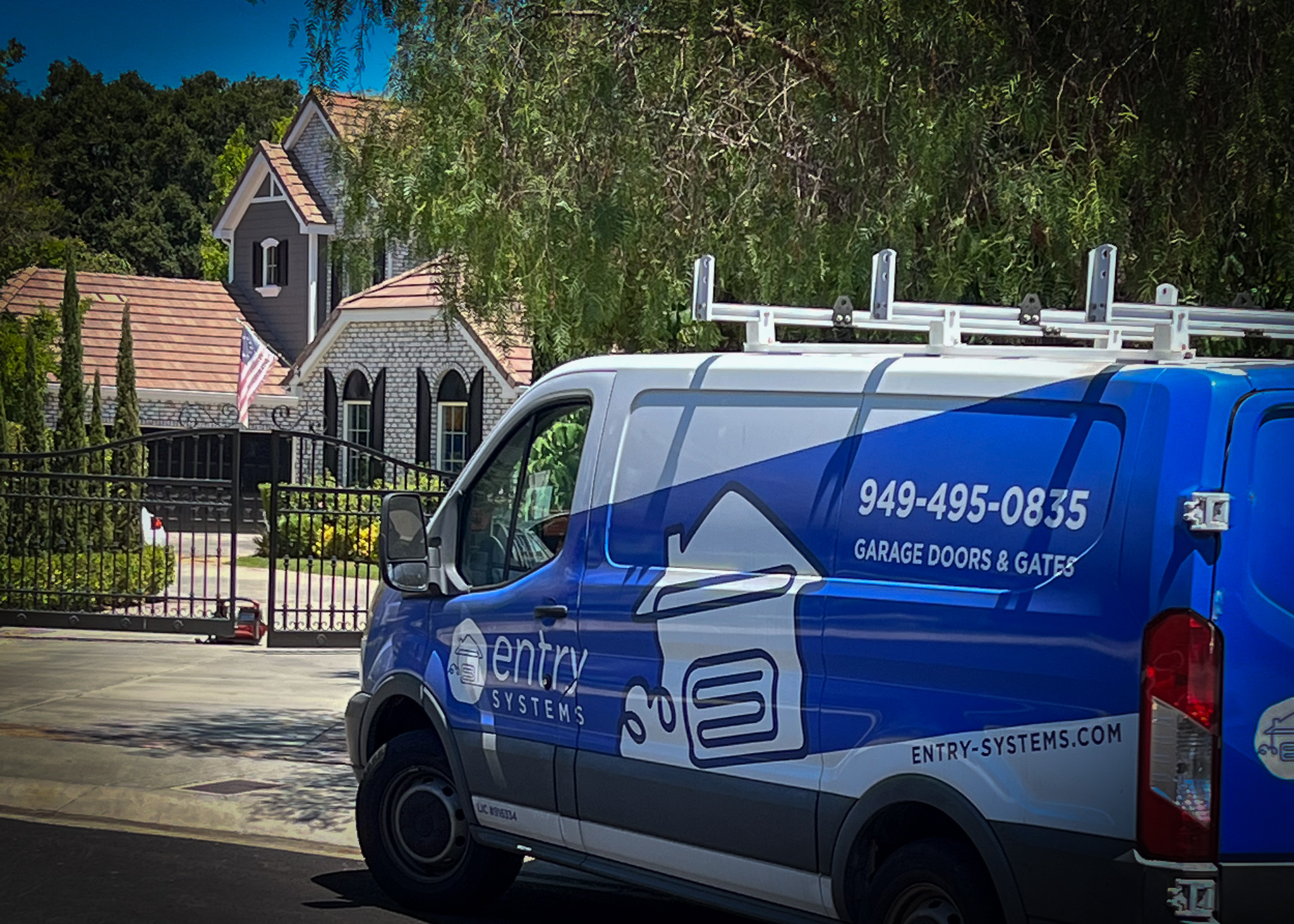 Pic of Entry Systems van in front of residential home with a security gate