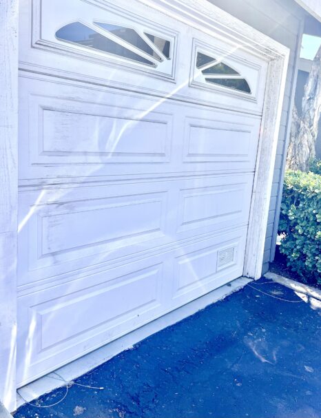 garage door shut with cables loose on the floor
