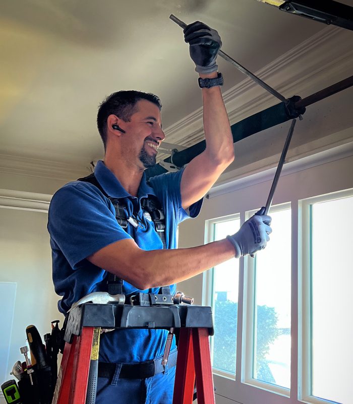 Image of garage door technician replacing springs