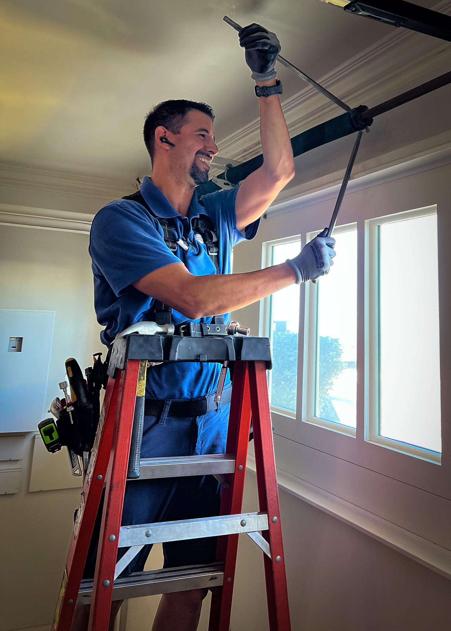 Image of garage door technician replacing springs