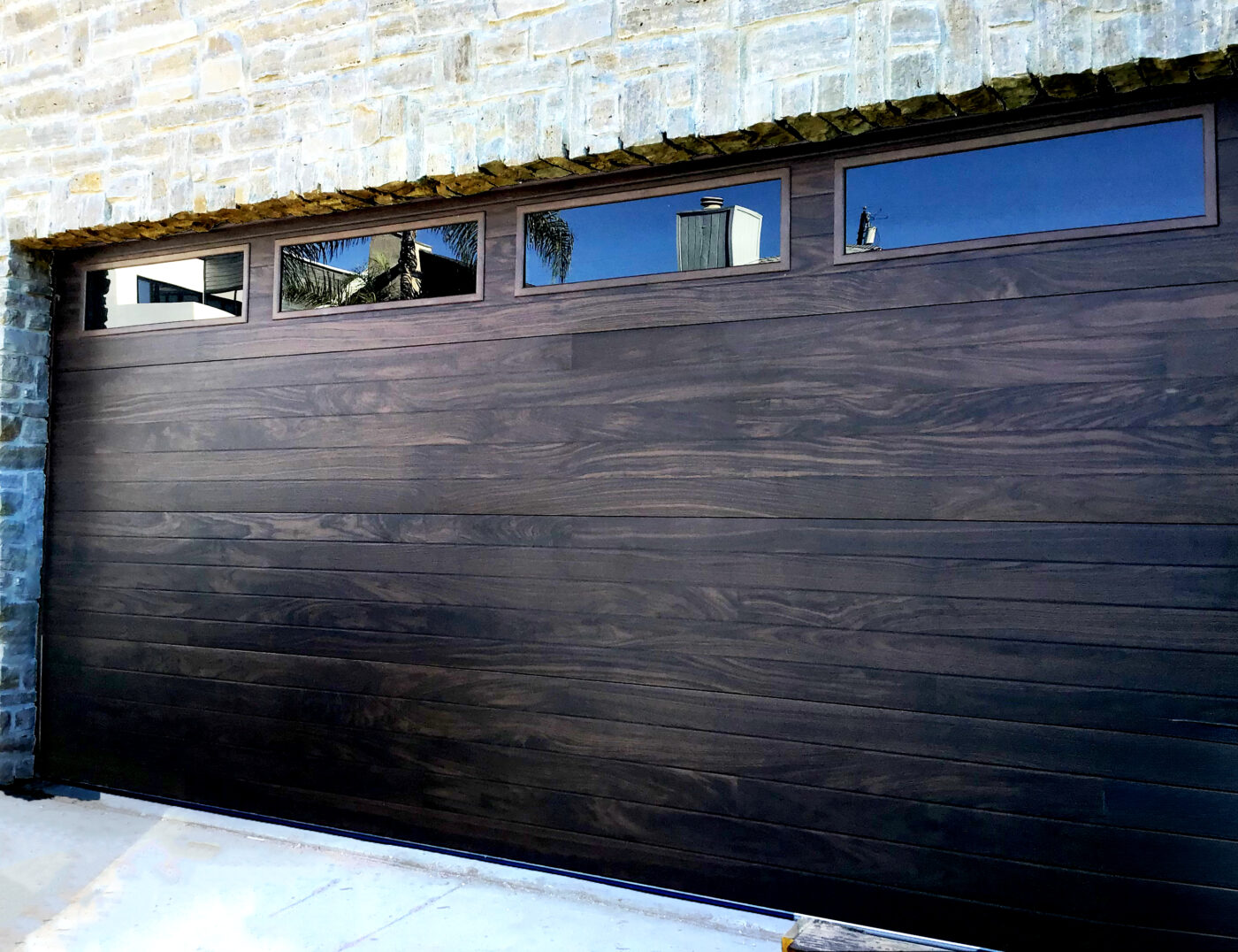 Before version of home in san clemente after new garage door install with new modern plank style.