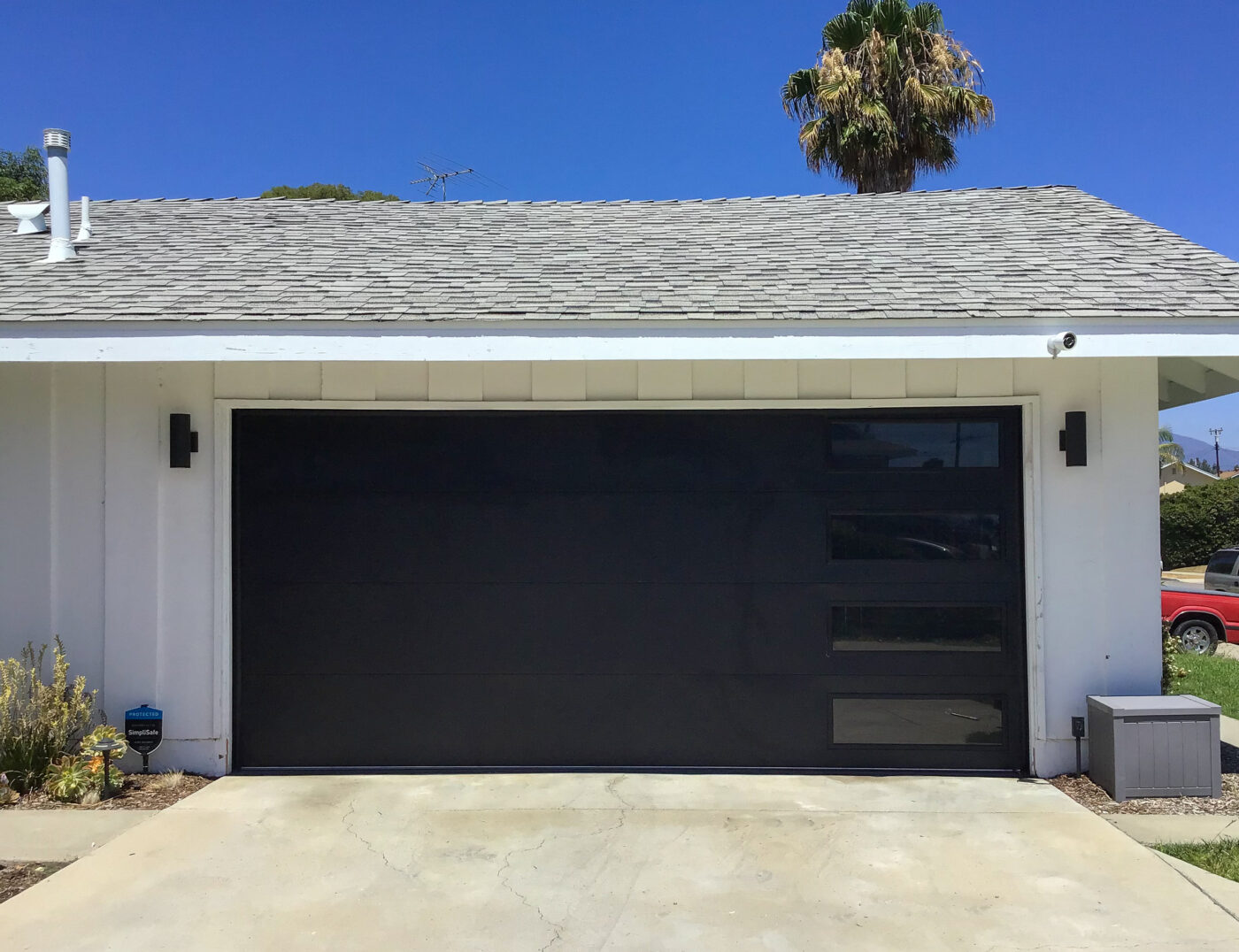 black garage door with vertical right windows after install