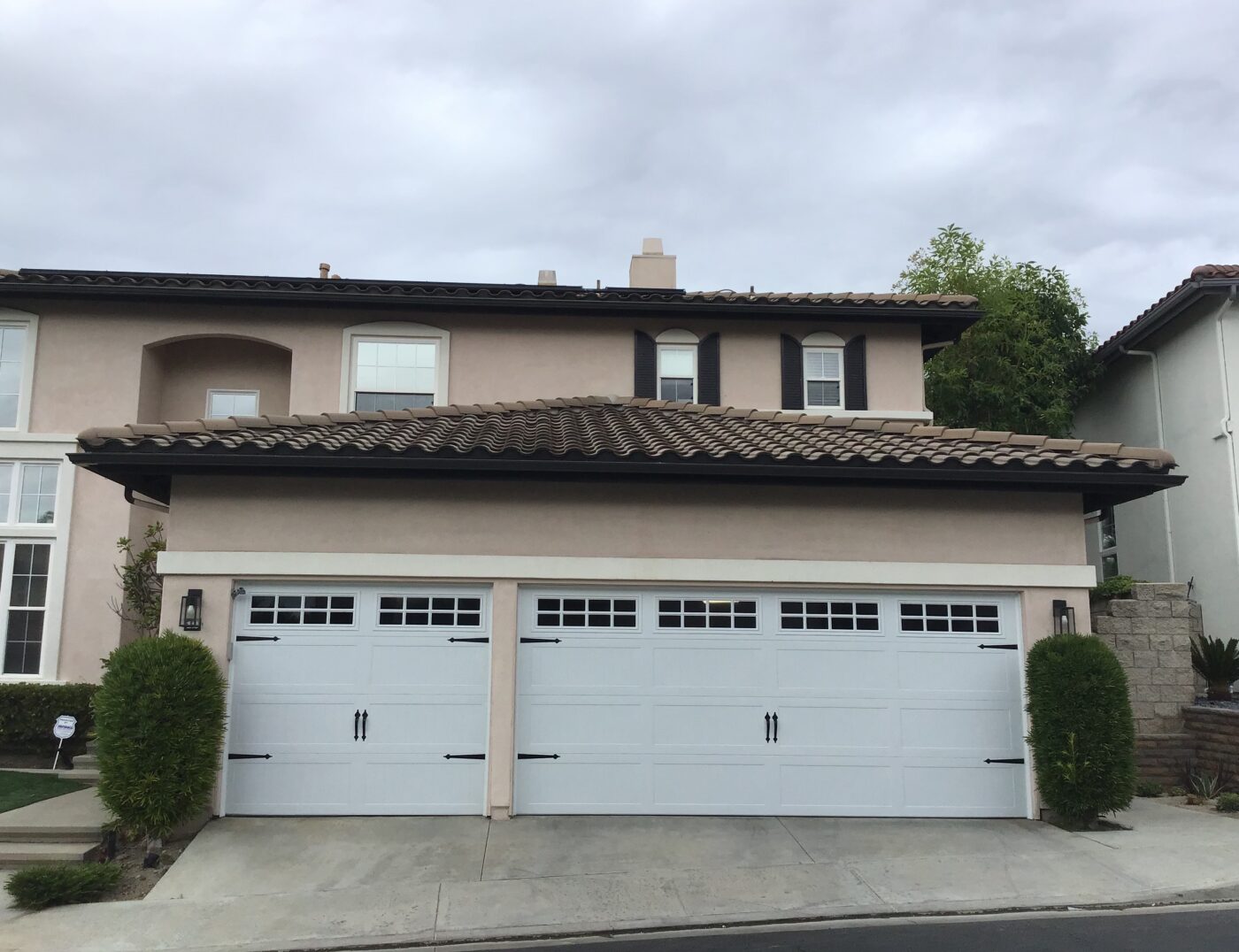after image of stamped carriage modern farmhouse garage door in white