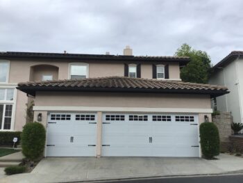 after image of stamped carriage modern farmhouse garage door in white