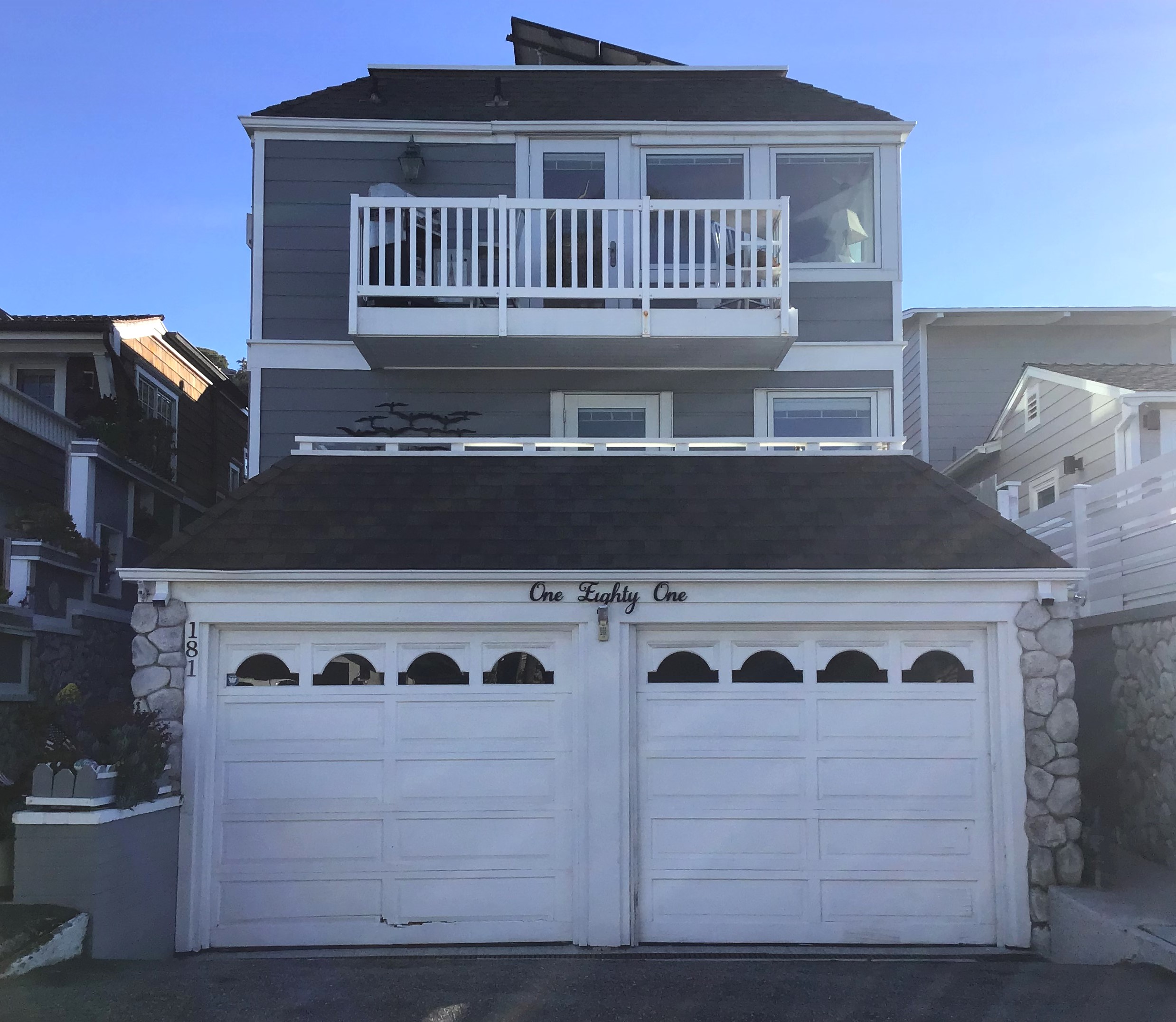 white damaged garage door in Laguna Beach