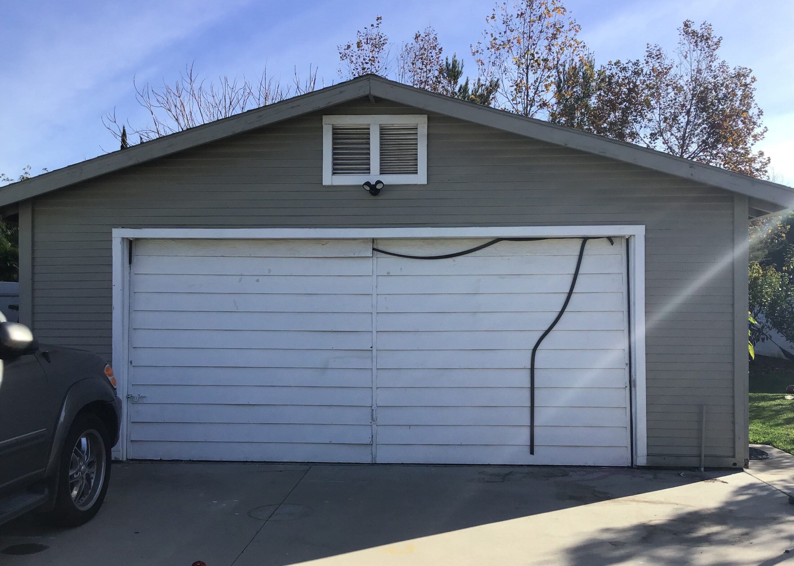White one piece old garage door in Orange, CA.