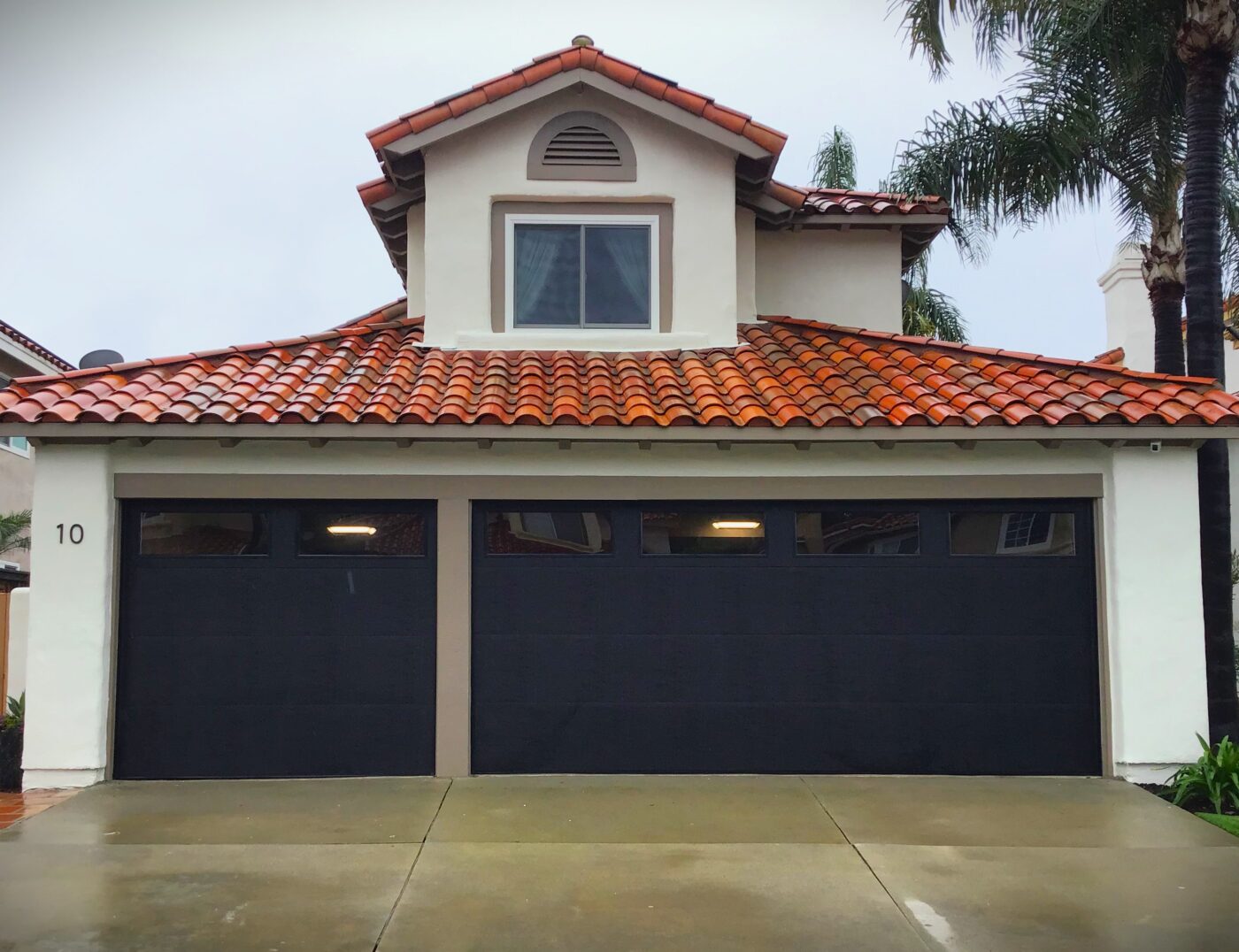 black garage door remodel in Laguna Niguel with windows