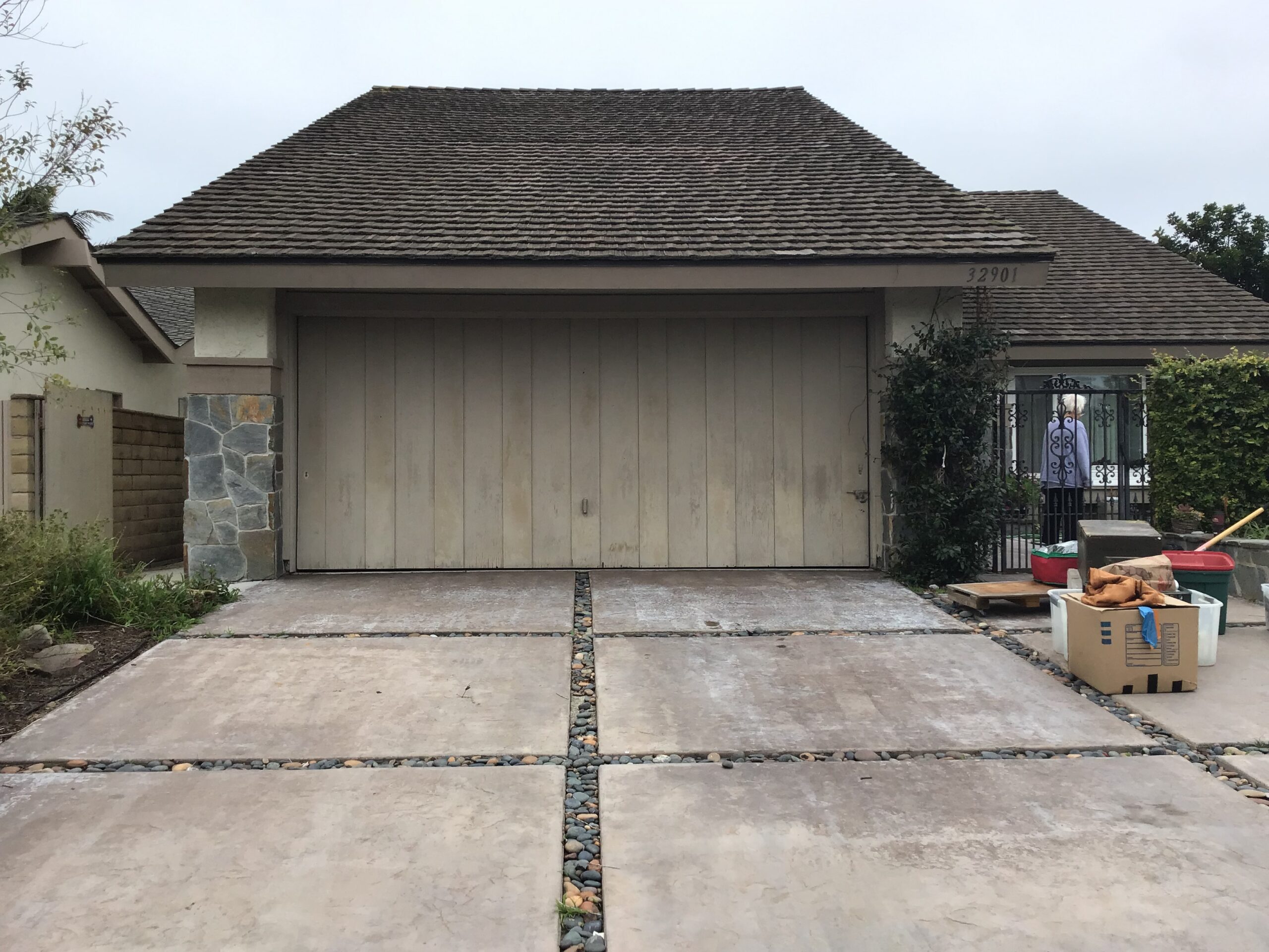 Tan one piece garage door before replacement