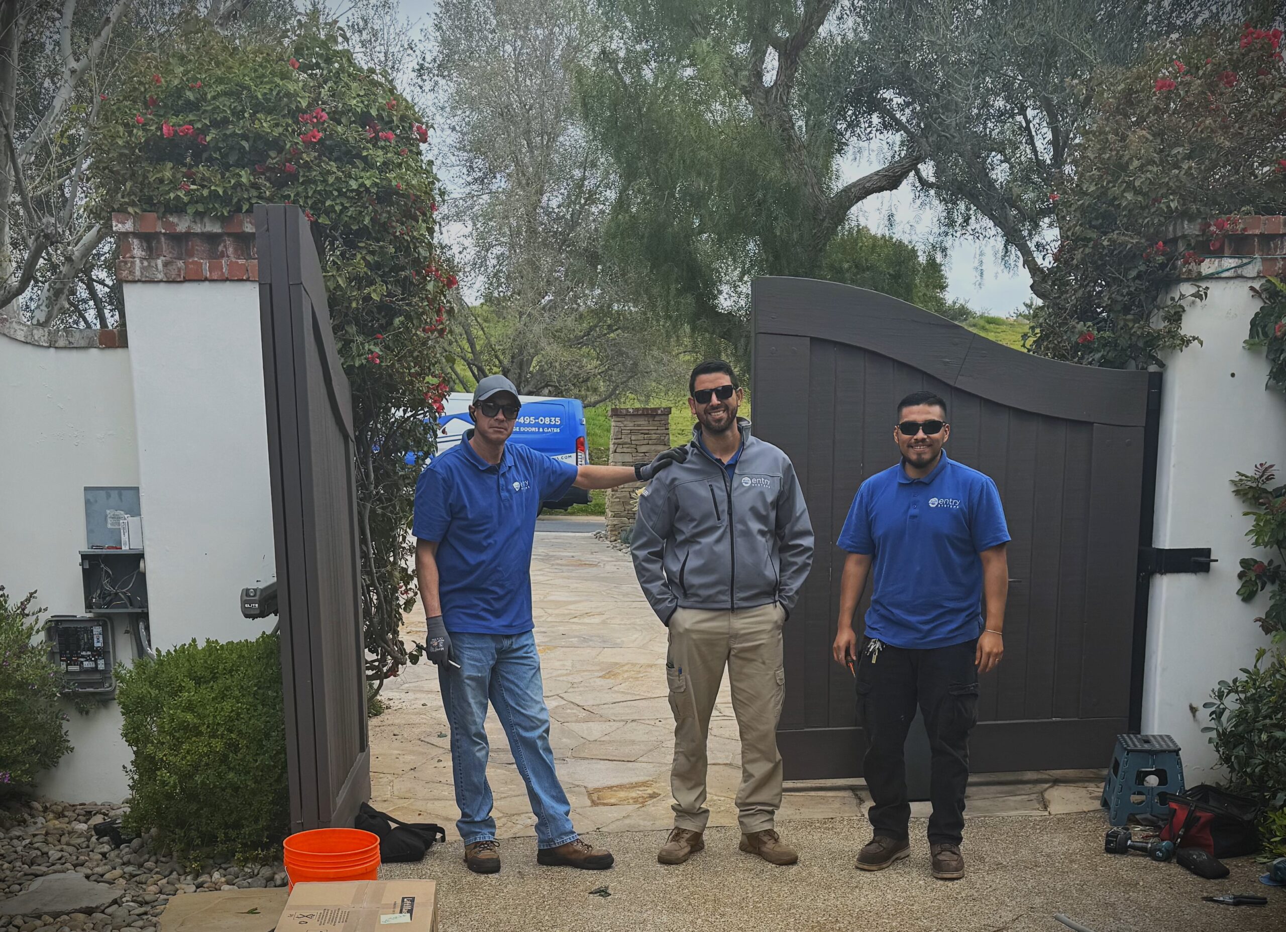 three gate technicians standing in front of electric gate in Irvine, CA