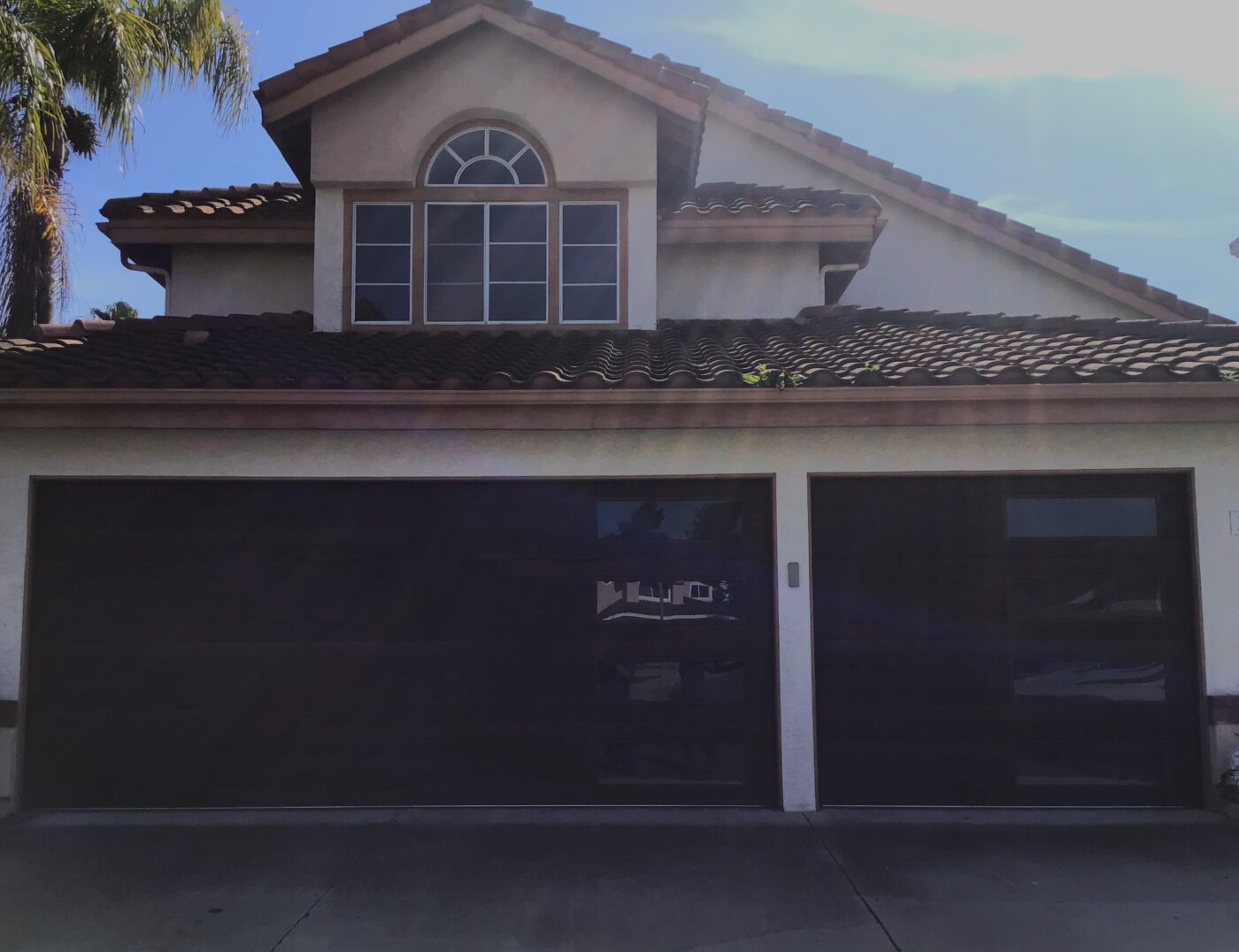 dark oak faux wood garage door with vertical windows in Dana Point after retrofit installation
