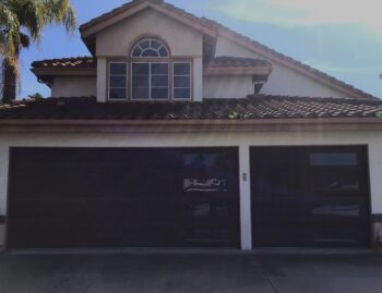 dark oak faux wood garage door with vertical windows in Dana Point after retrofit installation