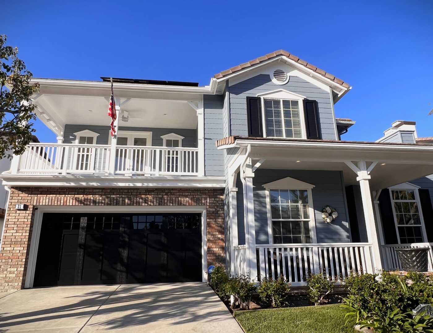 after shot of black overlay steel garage door with windows in coto de caza