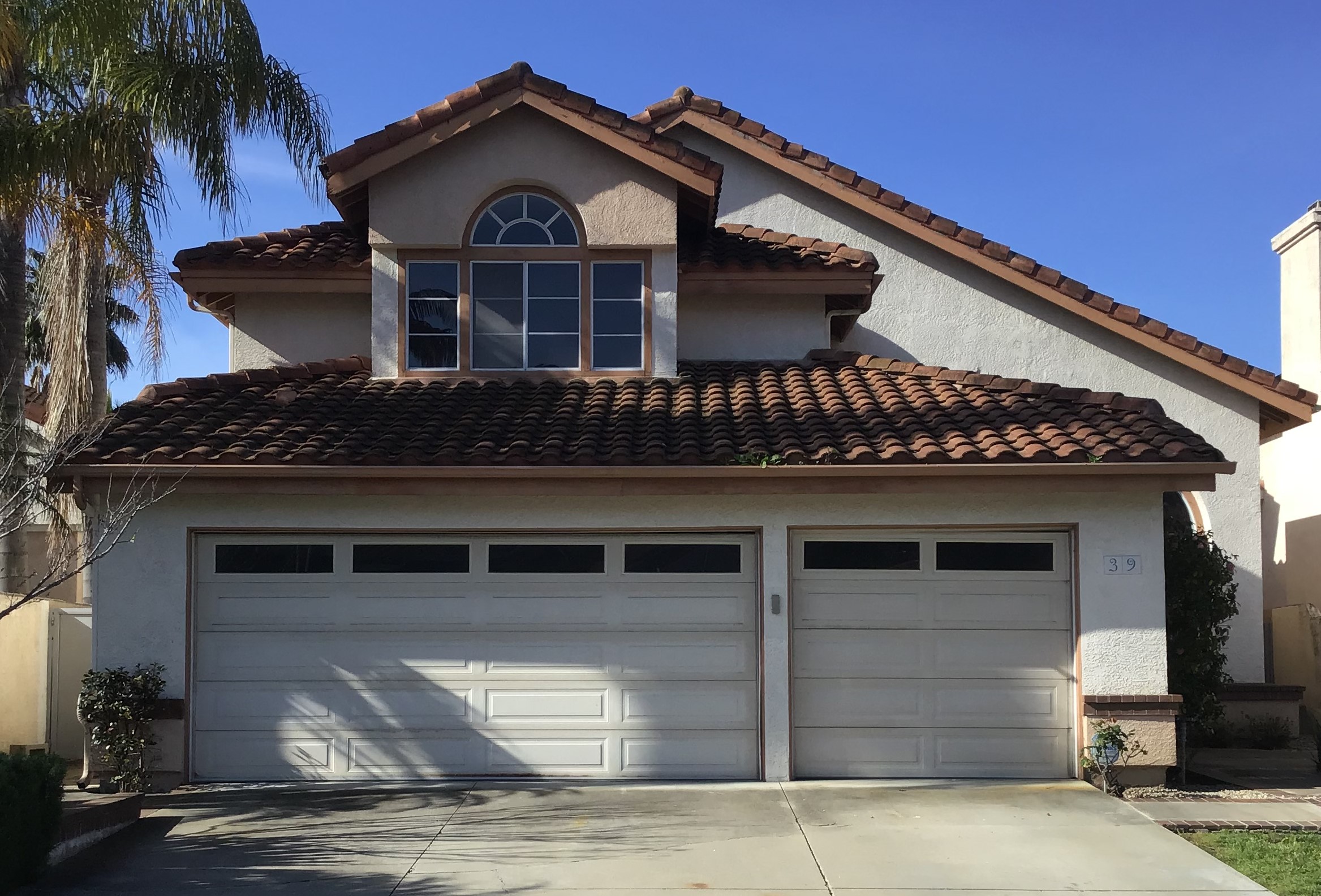 before remodel- white faded long panel garage door in Dana Point