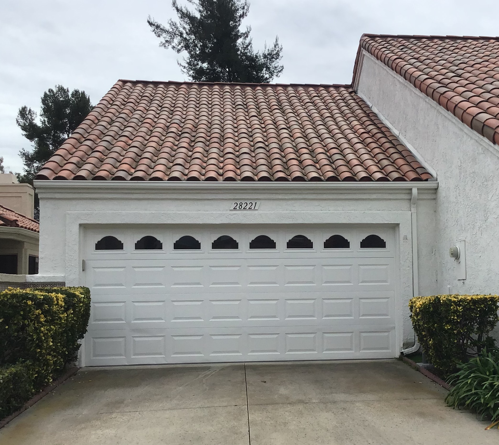 white short panel garage door in newport beach before replacement